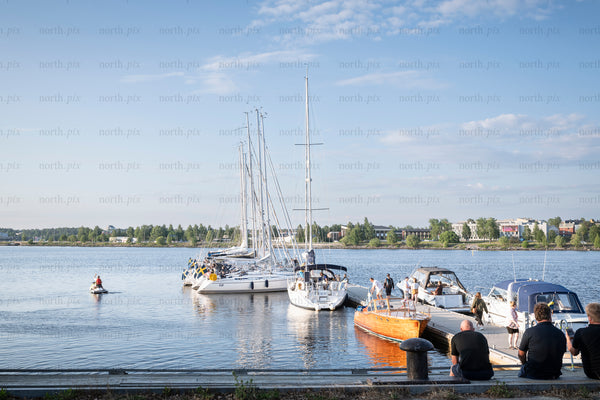 Sailboats and motorboats at a harbor in summer afternoon