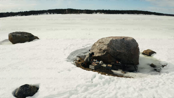 Winter in Luleå: Aerial drone view of person by frozen lake and snowmobile