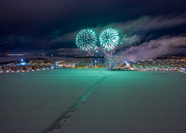 Nighttime winter fireworks scene in Luleå captured with drone