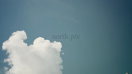 Low Angle View of Modern Wooden Architecture in City with Teal Sky and Clouds