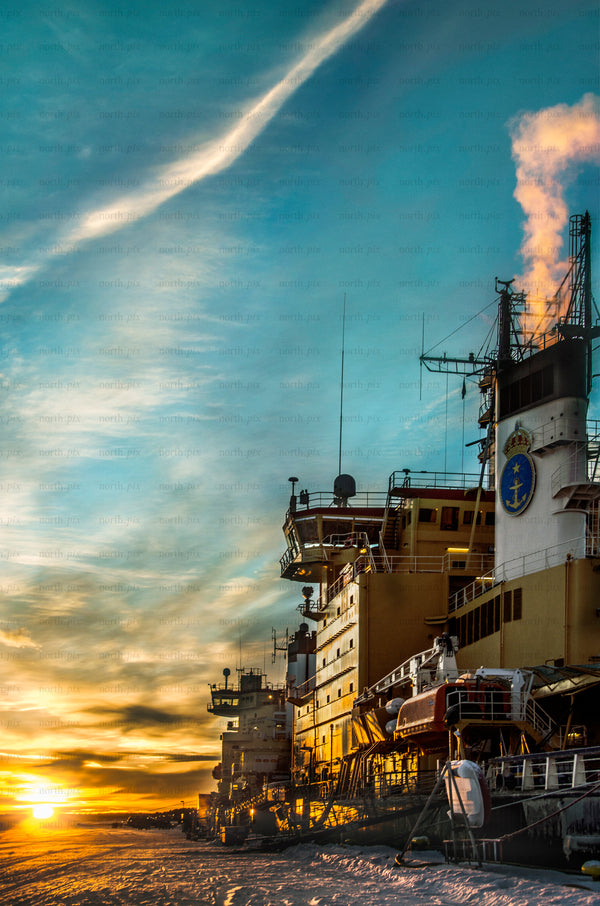 Icebreaker ships docked at harbor at sunrise