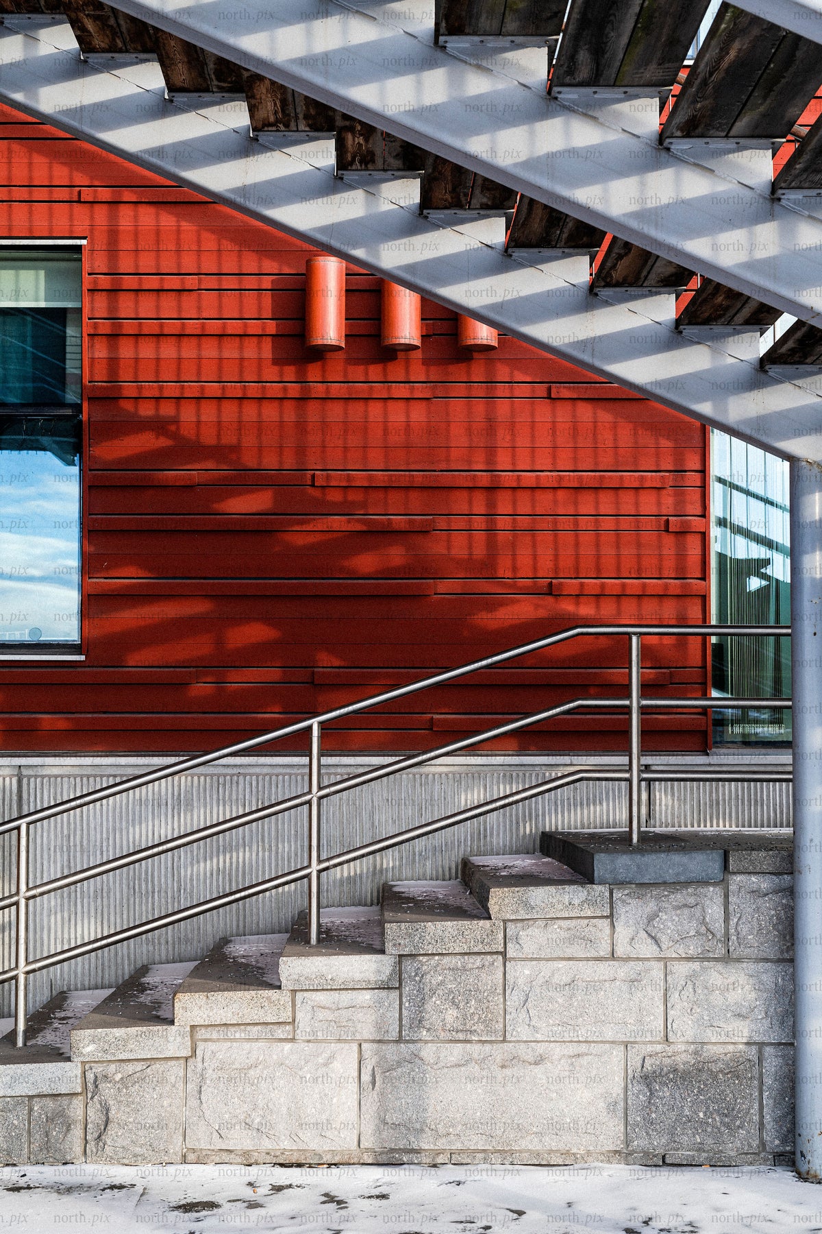 Staircase and red building exterior with metal railing