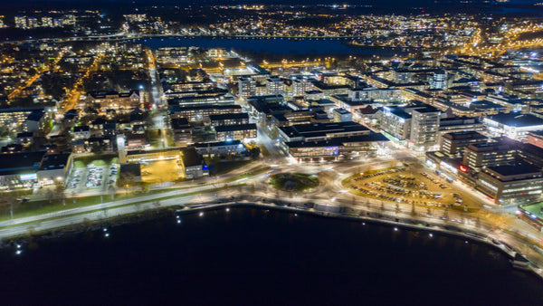 Night timelapse of Luleå: Aerial view of illuminated cityscape, roads, and Luleå energi arena