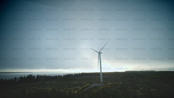 Rotating wind turbine by the sea: Aerial view of sustainable energy in Finland
