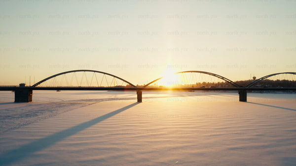 Golden hour sunset over a bridge in Luleå during winter
