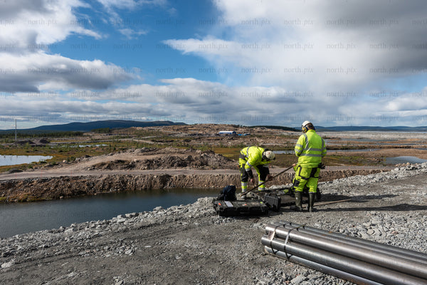 Construction workers at quarry site, daytime
