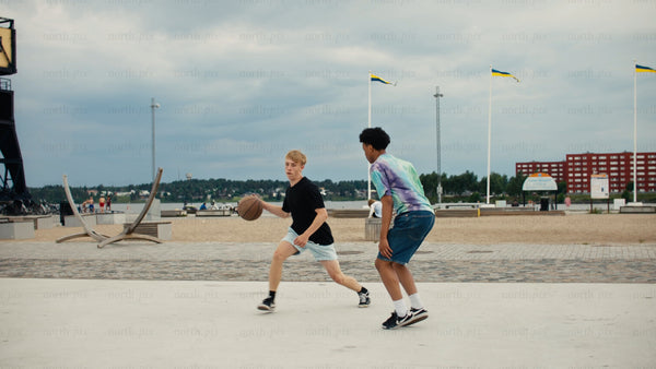 Urban summer basketball: Teenagers enjoying a game by the beach in Luleå