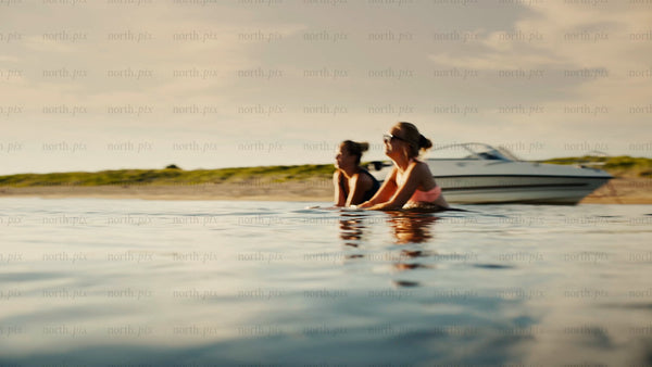 Women swimming in the Baltic Sea at golden hour, Luleå archipelago