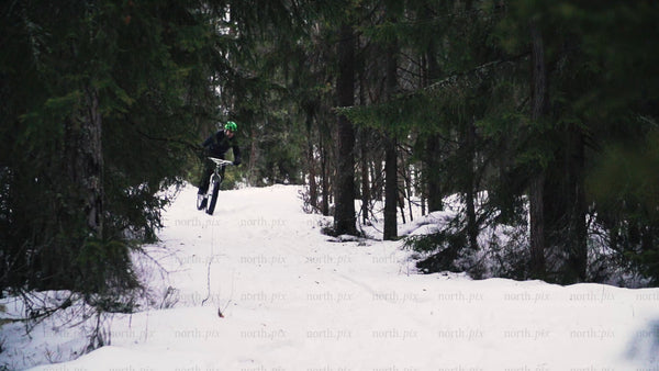 Fatbiking in winter: Man rides snowy forest trail in Luleå