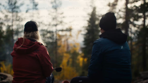 Couple enjoys autumn view in Luleå forest during golden hour