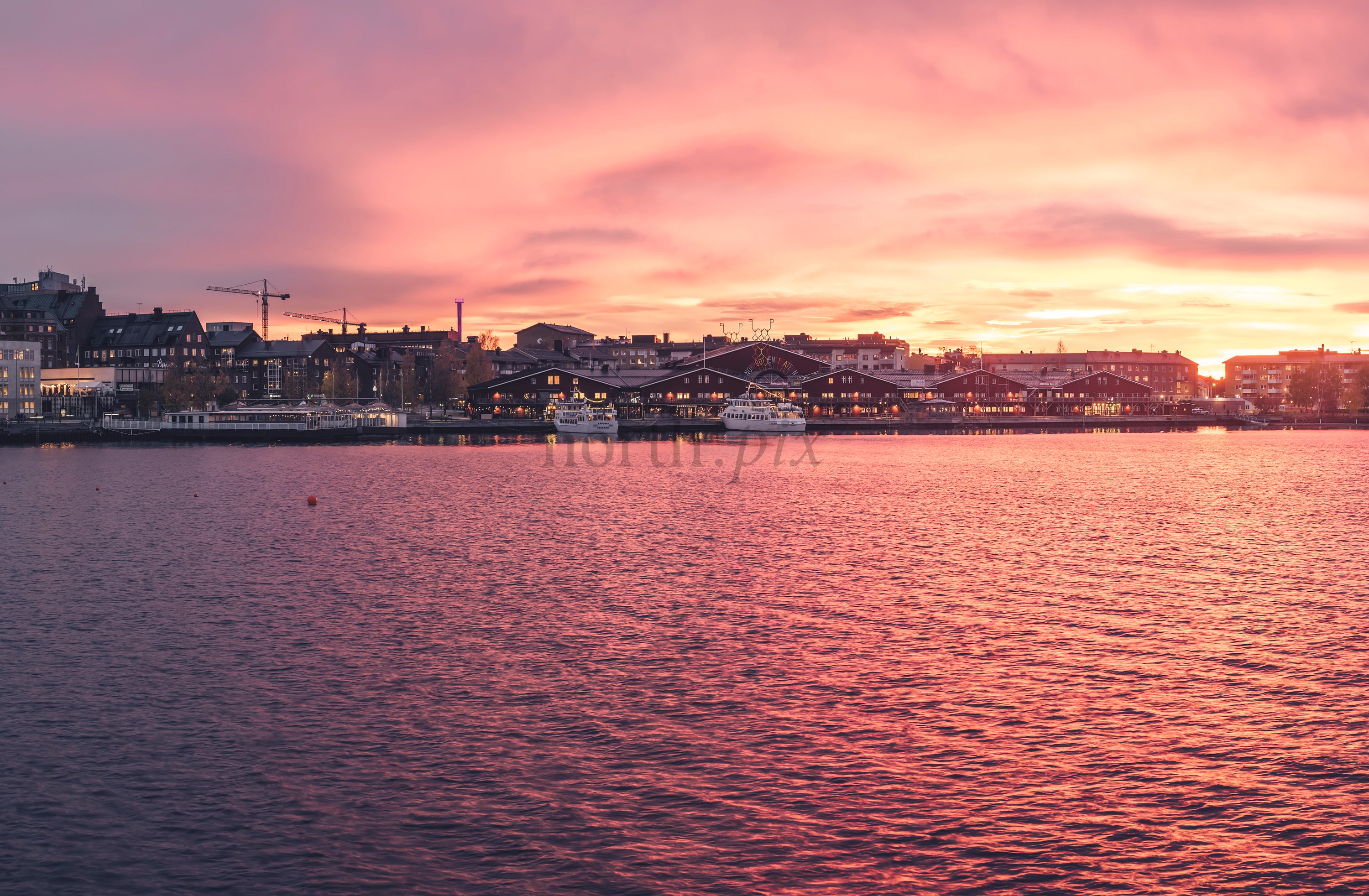 Harbor skyline at sunset with waterfront buildings