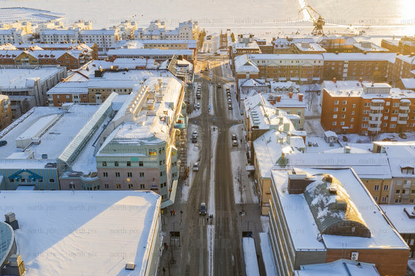 Snowy Luleå city center aerial view of winter streets and harbor at sunrise