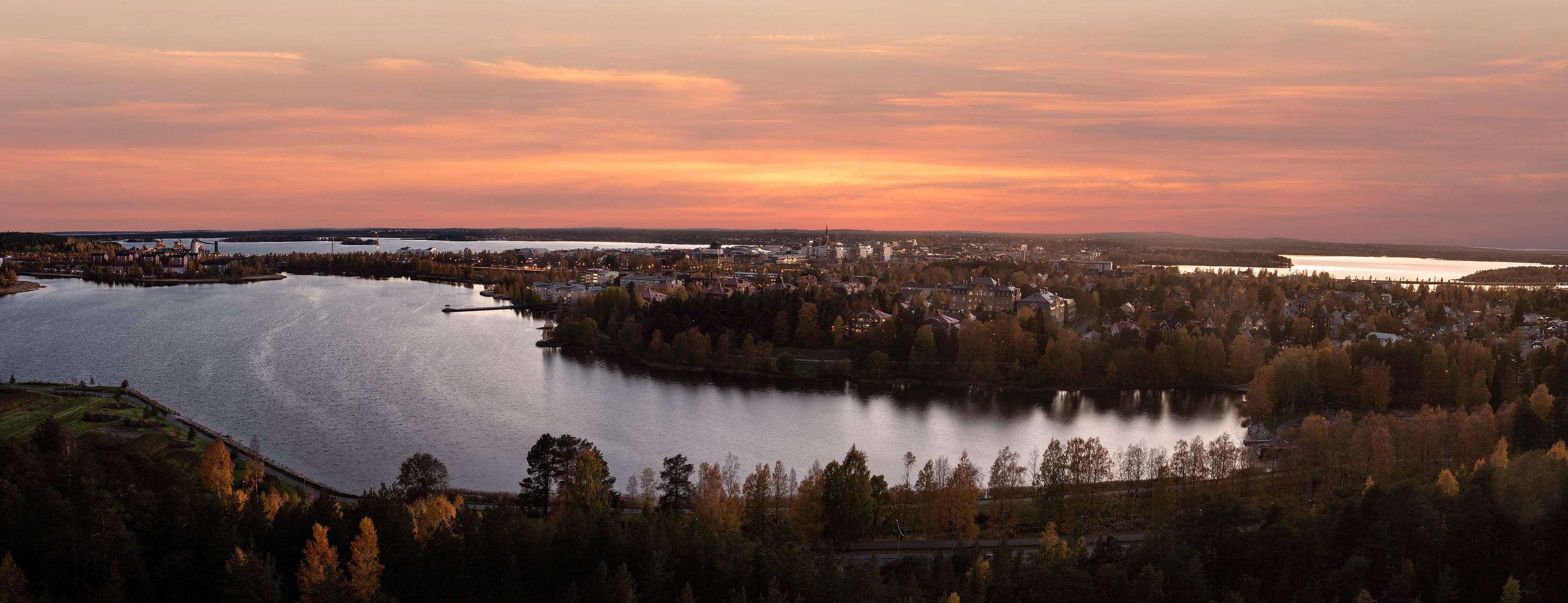 Panoramic view of lakeside town at sunset