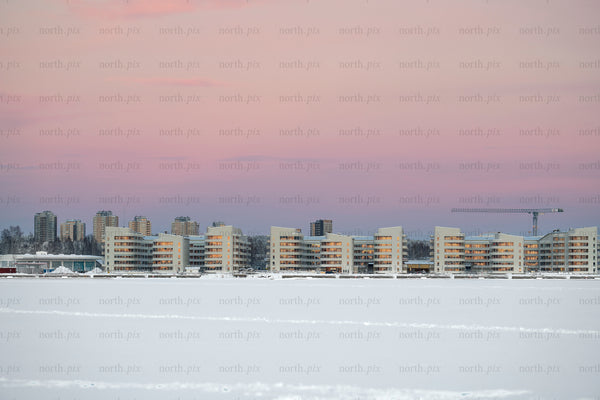 Kuststad - modern waterfront apartment buildings by frozen sea at sunrise