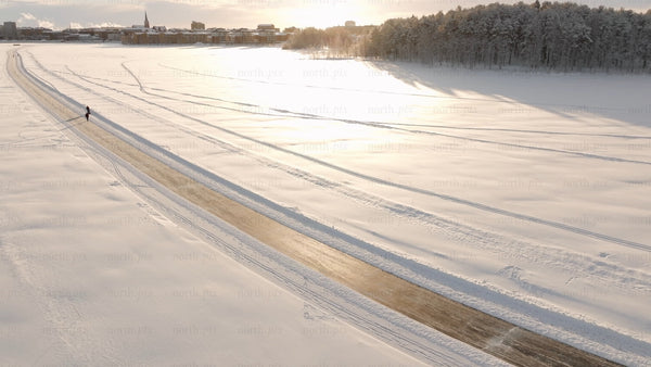 Winter ice skating in Luleå: Scenic aerial drone footage of frozen lake landscape