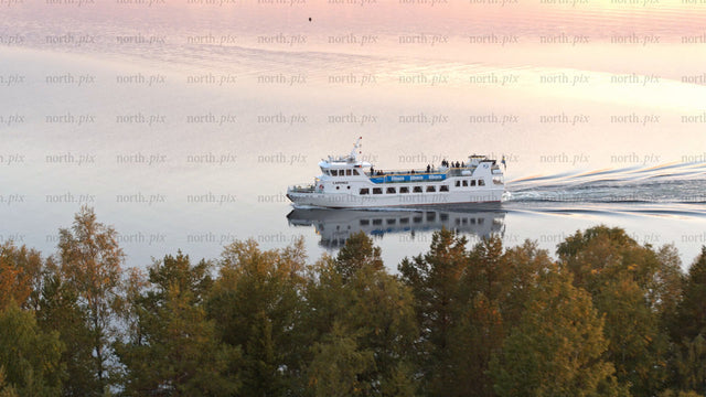 Luleå river sunset ferry: Aerial view of calm water and colorful sky