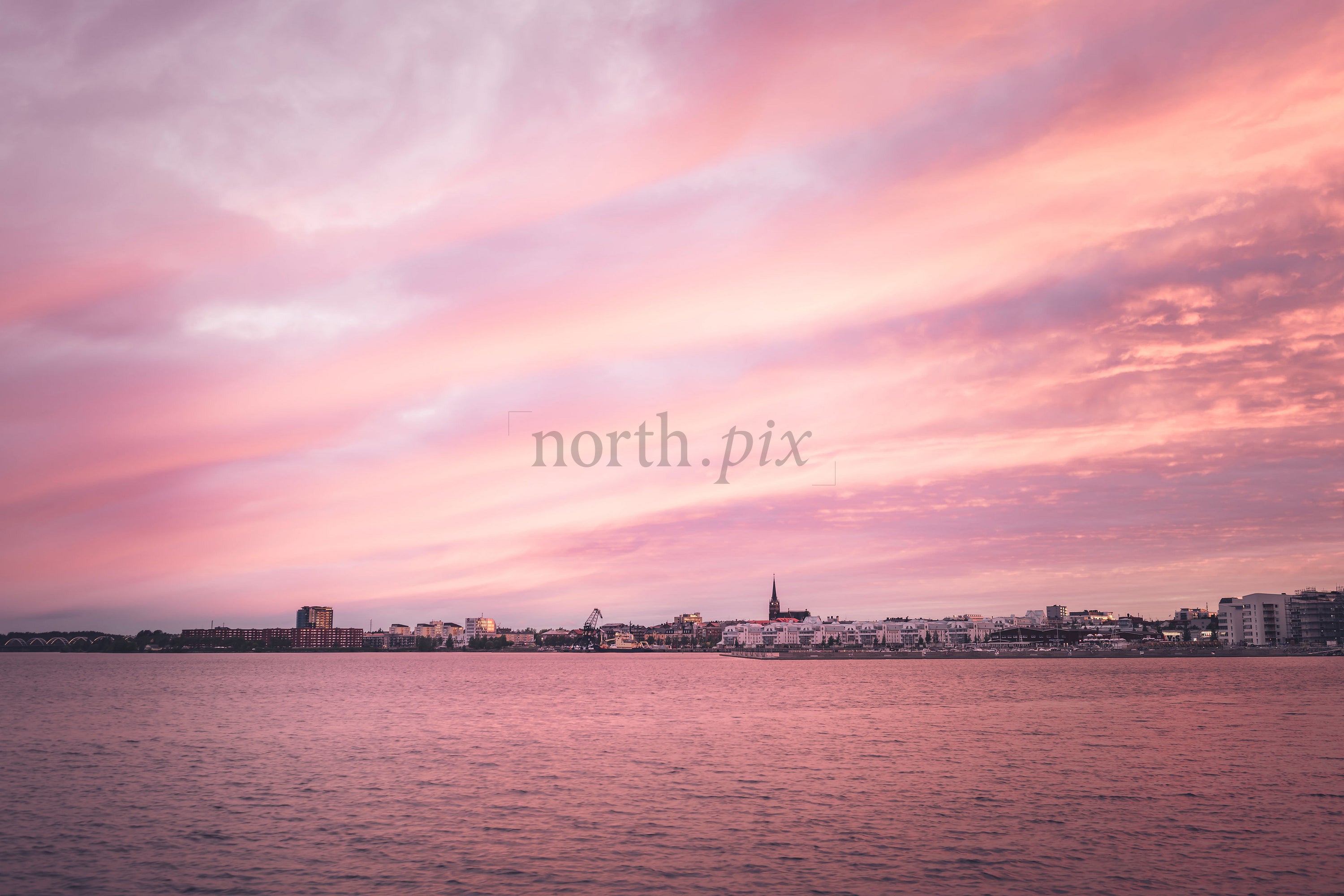 Harbor skyline with church spire at sunset
