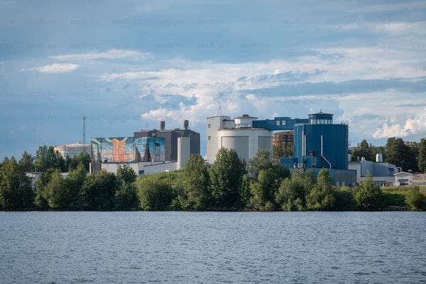 Industrial plant by a lake in summer afternoon