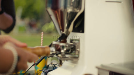 Barista Grinds Coffee Beans for Espresso in Outdoor Urban Setting