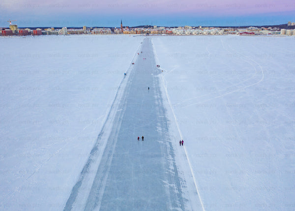 Drone view of winter ice path in Luleå during blue hour