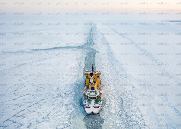 Icebreaker ship navigating arctic waters during winter morning