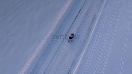 White Car on a Snowy Ice Road in Luleå, Sweden During Winter Twilight