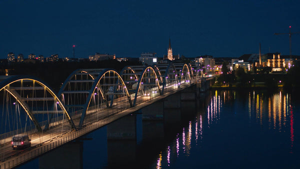 Luleå cityscape at twilight: Cars crossing bridge over river