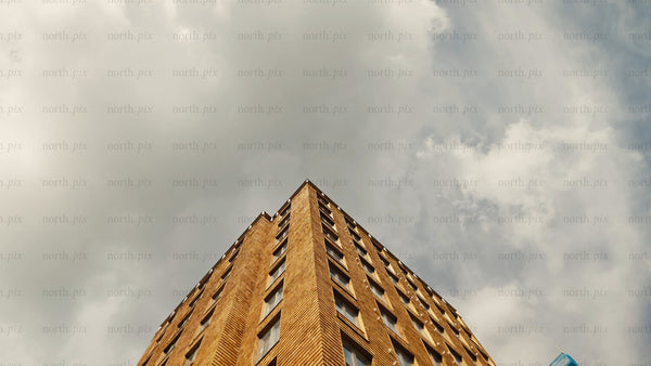 Modern wood architecture: A low angle tilt-up view against a cloudy sky