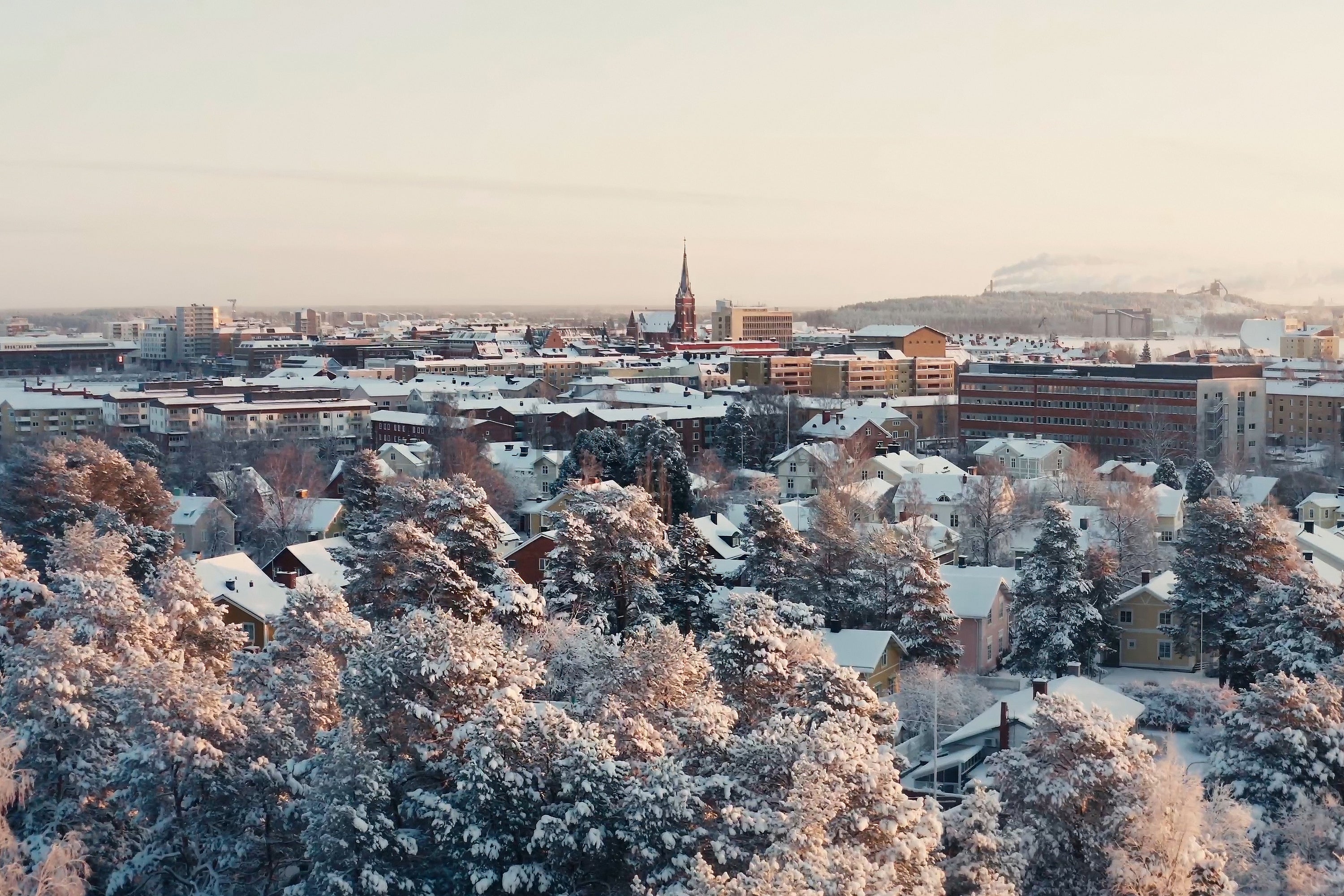 Snowy City Center View Over Luleå With Trees, Homes, and Winter Lighting