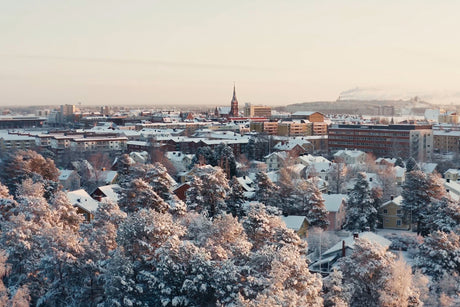 Snowy City Center View Over Luleå With Trees, Homes, and Winter Lighting