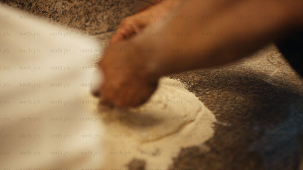 Chef preparing pizza dough: A close-up look at pizza making in a restaurant kitchen