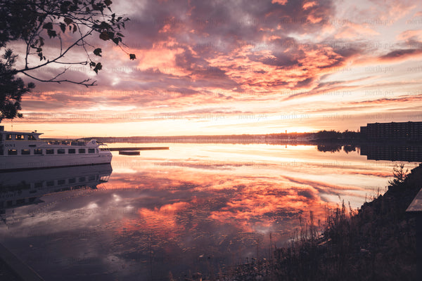 Passenger ferry docked at harbor at sunset