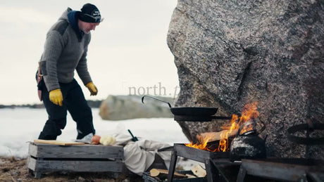 Winter Cooking in the Luleå Archipelago: Man Prepares Food by Open Fire