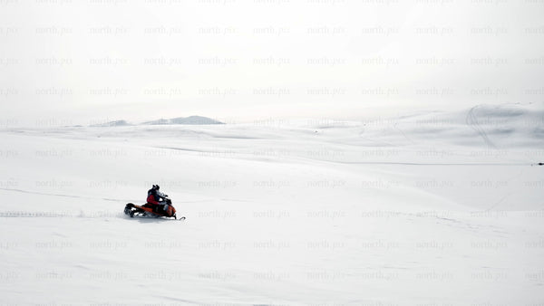 Snowmobiling across a snowy landscape in ritsem
