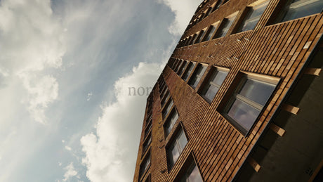 Modern Wood Architecture: Sliding Shot of Multi-Story Residential Building with Cloudy Sky