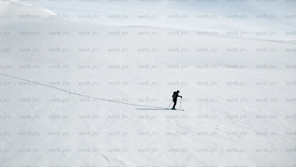 Lone skier in snowy mountain landscape