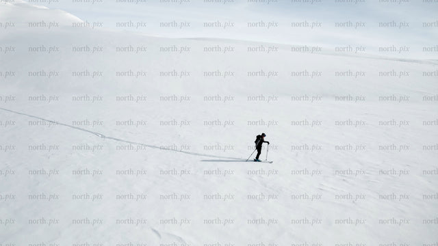 Lone skier in snowy mountain landscape