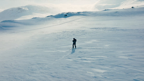 Cross-country skiing in a snowy mountain landscape