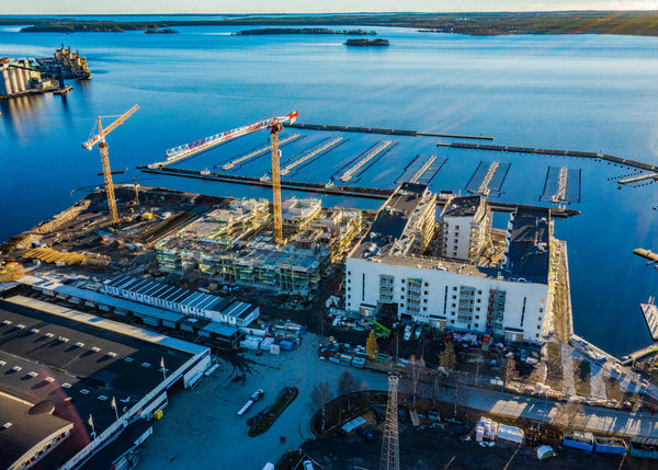 Aerial view of coastal construction site by water during daylight
