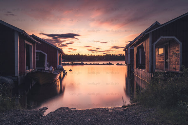 Brändöskär - red cottage vishing village and boat at lake during sunset