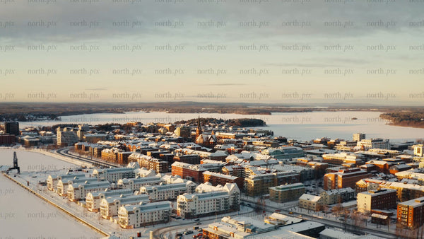 Aerial drone view of snow-covered Luleå, in winter at golden hour