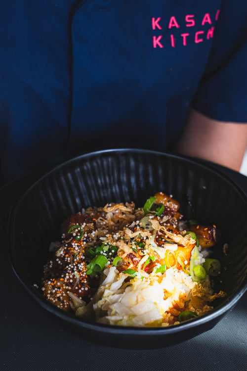 Rice bowl with grilled chicken and pickled cabbage, close-up