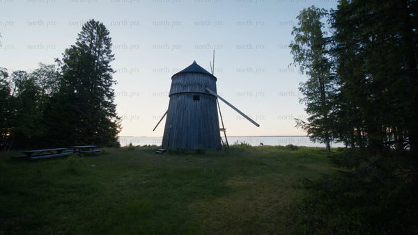 Old wooden windmill on a remote Swedish coastal island at twilight in summer