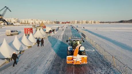 Winter Day in Luleå: Tractor Clears Snow on Frozen Waterway