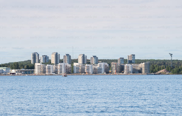 Waterfront apartment buildings on coastline at midday