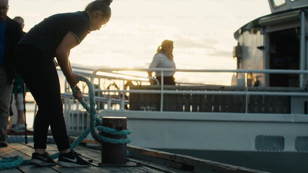 Mooring a boat in Luleå: A golden hour scene at the pier