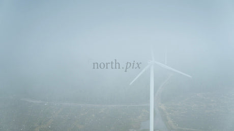 Wind Turbine in Foggy Forest near Ocean in Haraholmen, Sweden: Renewable Energy