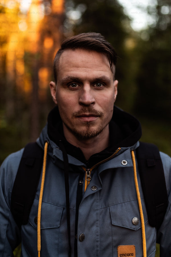 Portrait of man in forest at golden hour