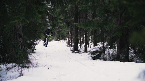 Fatbiking in winter: Man rides snowy forest trail in Luleå
