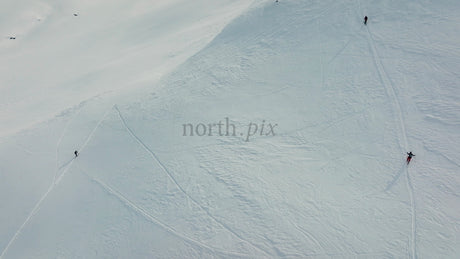 Skiers and Snowboarders Descend Snowy Mountain at Riksgransen, Sweden